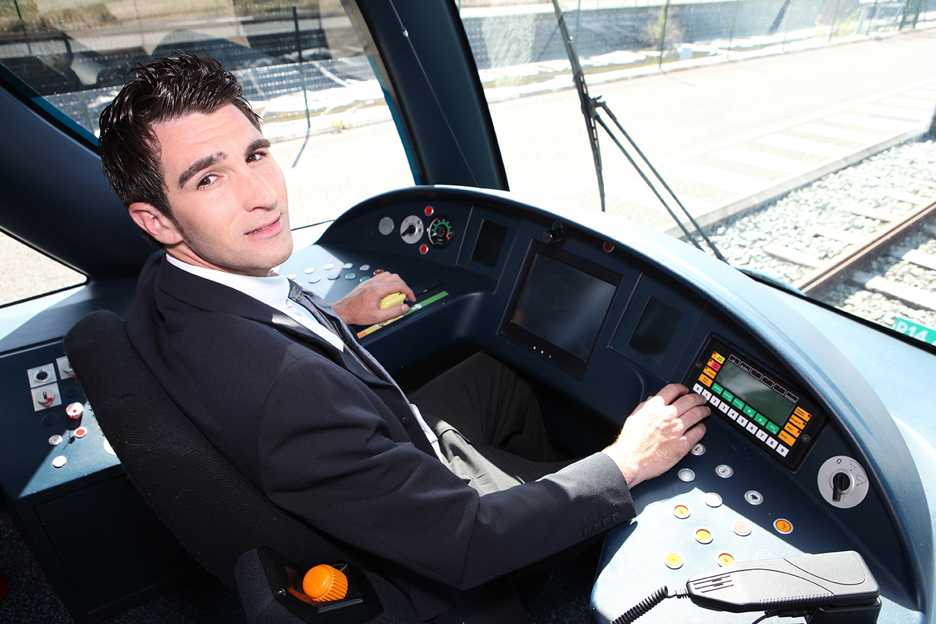 Young man driving a tram