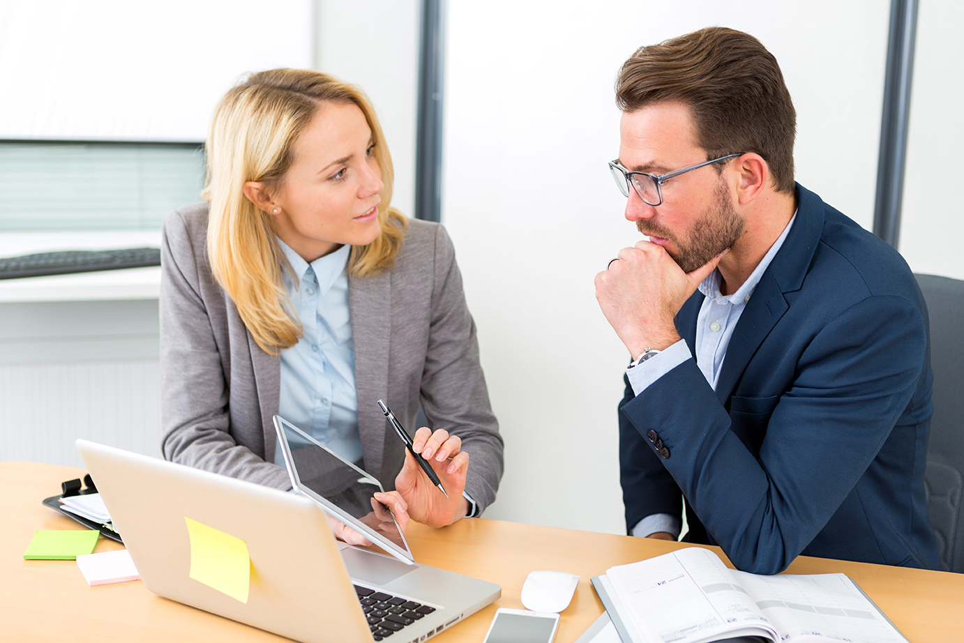 Businessman and his assistant working together at the office