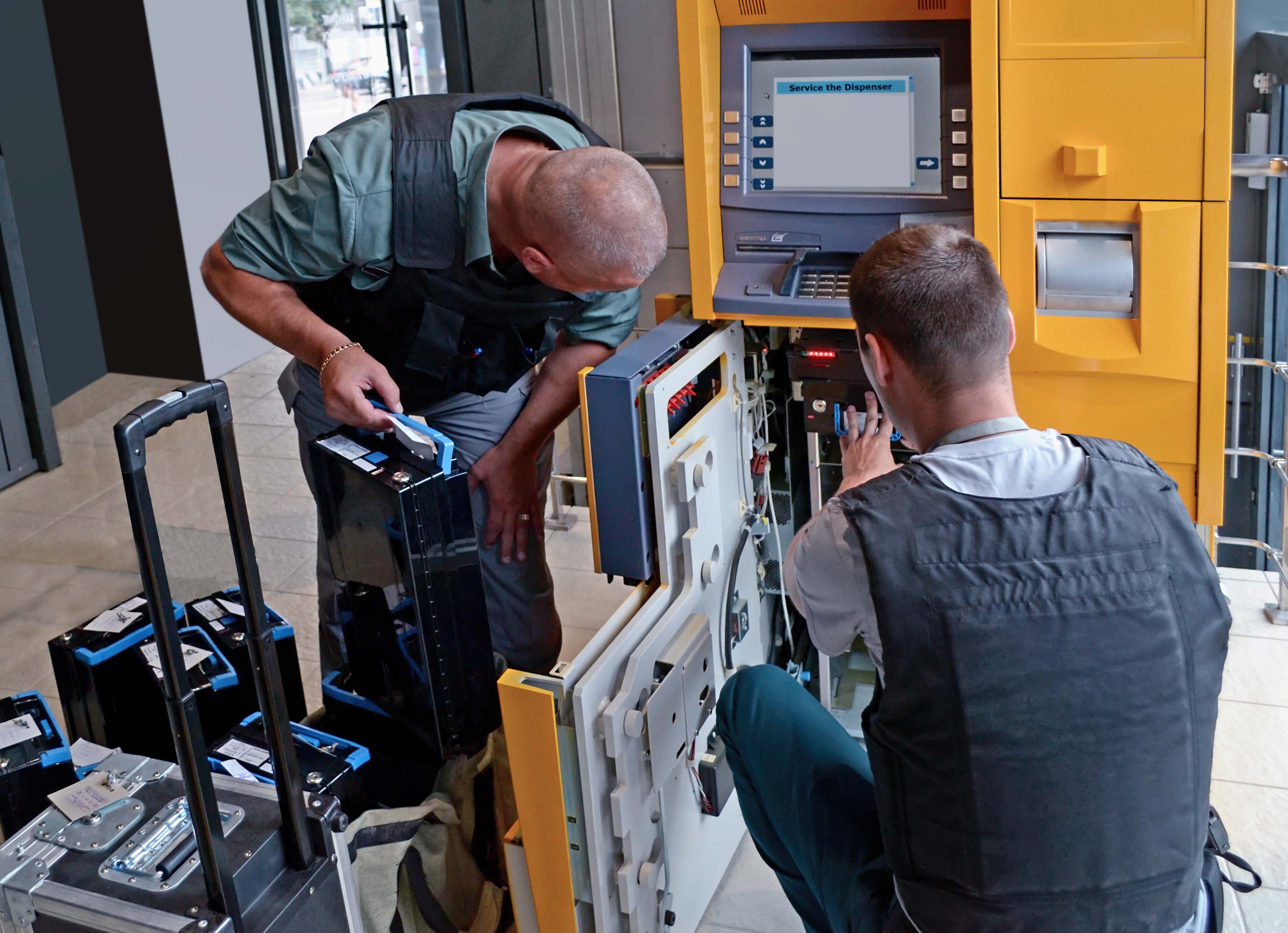 Security Service is doing service for ATM. ATM loading with money