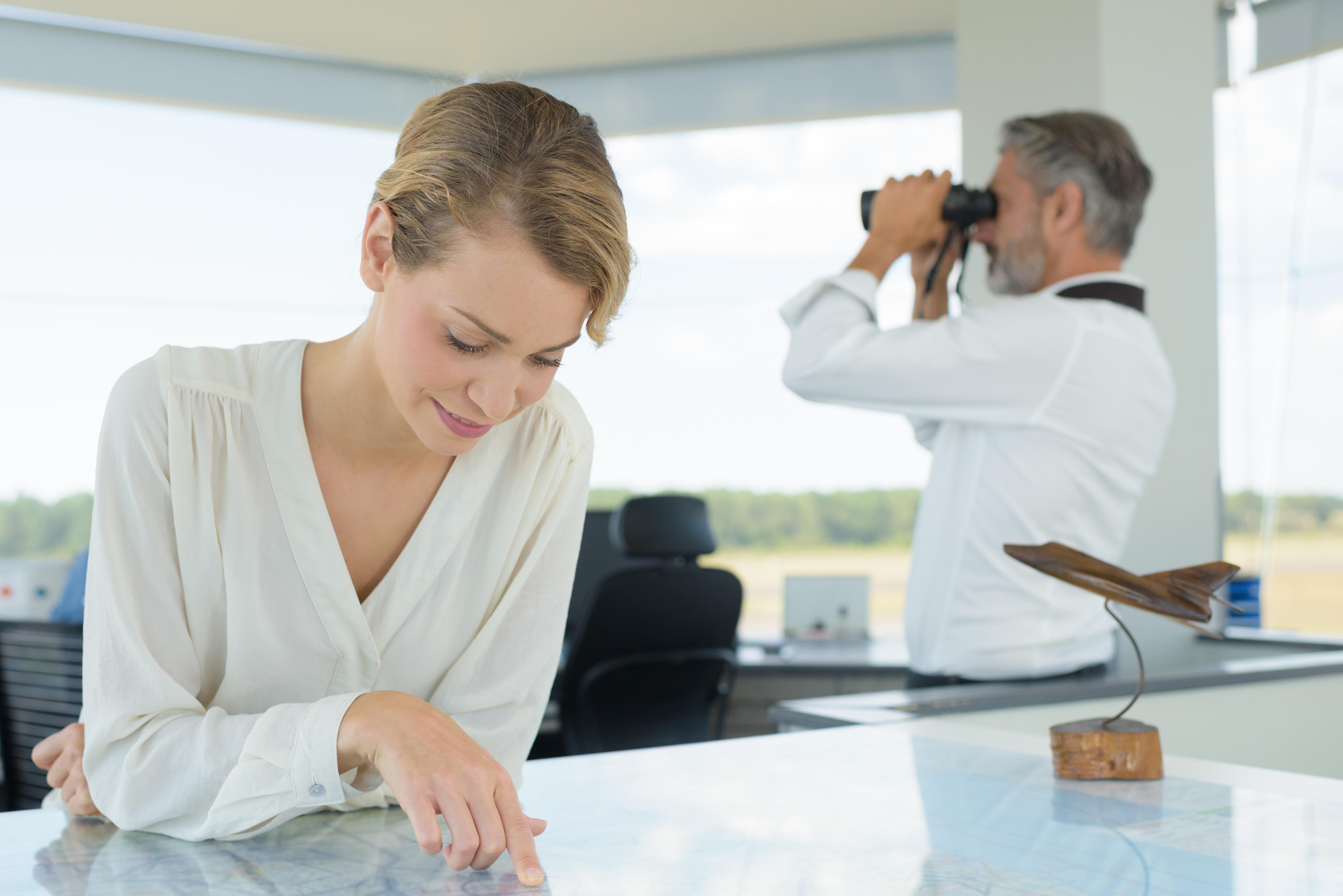 woman on the airport tower studying the map